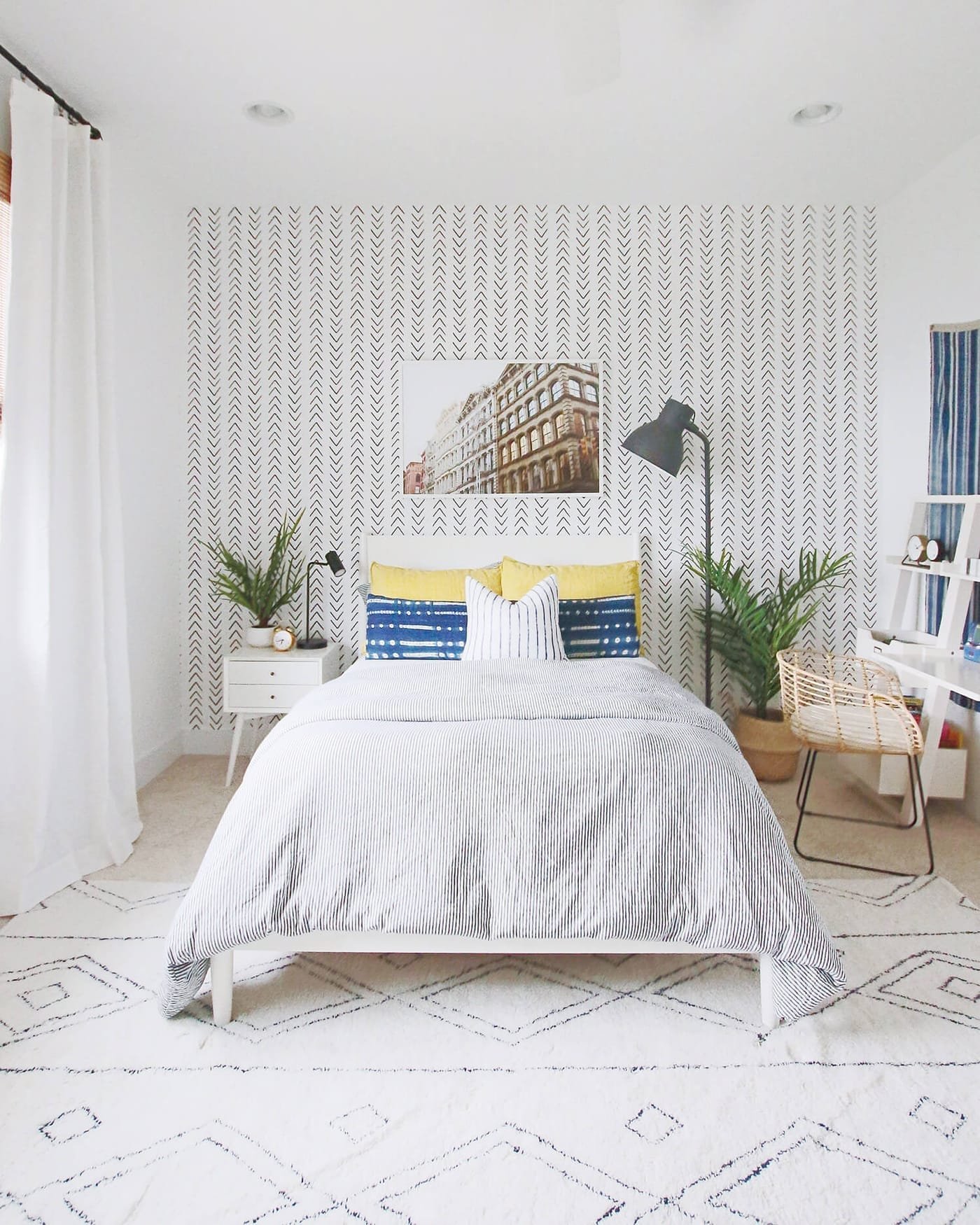 Bright private bedroom at the Chiwash surf house with white linen and blue accent pillows